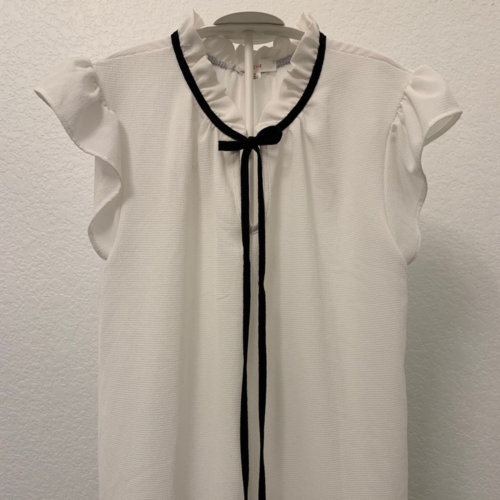A Blouse from Mine in the color white and black.